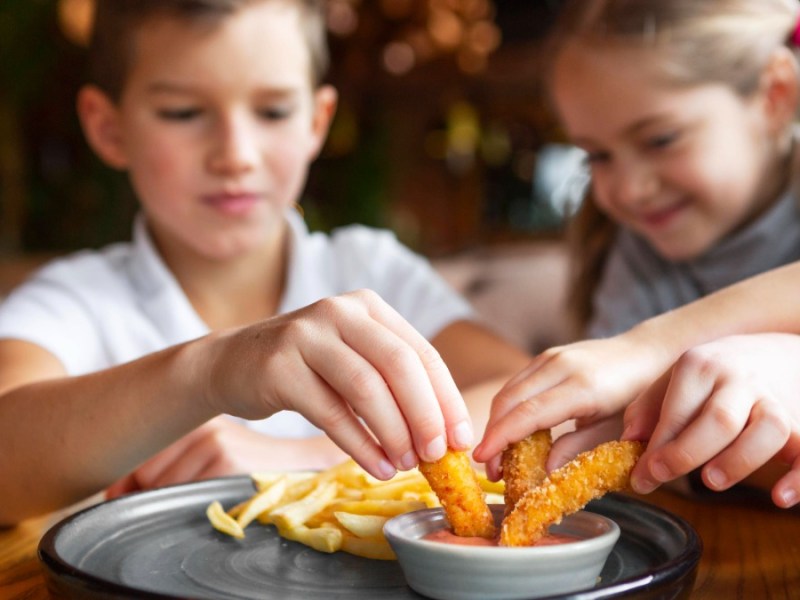 Kinder essen mit Begeisterung Fast Food