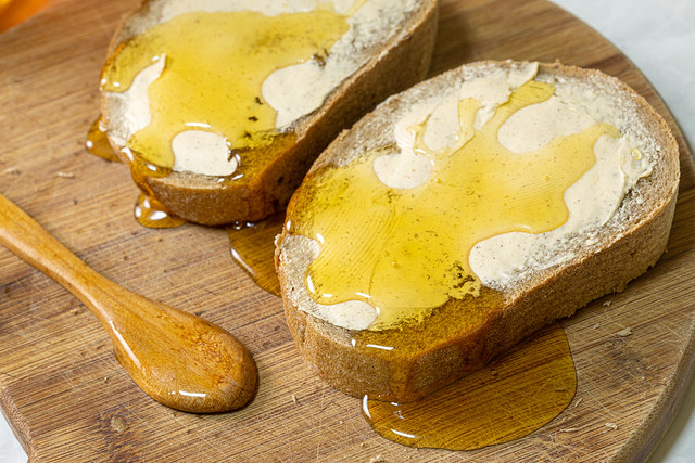 Bread with butter and Honey on the wooden board